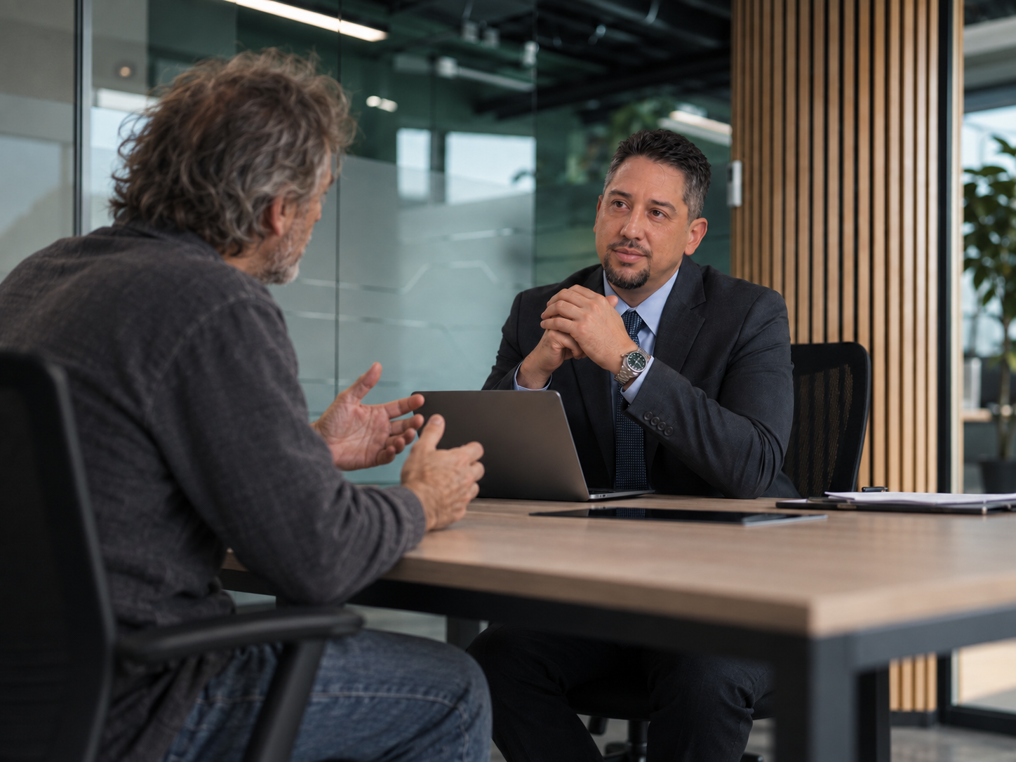 Illustrative dramatization of Justin Kirk Tabayoyon meeting with a client for legal guidance.